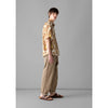 Toast - Alfie Stripe Organic Cotton Trousers - Ecru/ Brown - Model side on 