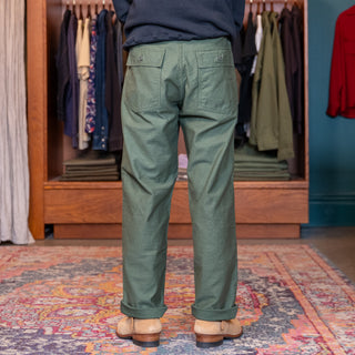 Person wearing Standing in a  room with wooden wardrobORSLOW GREEN FATIGUESe and colorful rug
